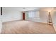 Spacious living area with wood-look floors, a large window, and stylish lighting at 565 Greenbriar Townhouse Way, Las Vegas, NV 89121