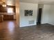 Open living space featuring new flooring with a partial view into the kitchen at 565 Greenbriar Townhouse Way, Las Vegas, NV 89121