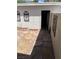 Private patio area with decorative stone, pebble accents, garden hose and private access door at 565 Greenbriar Townhouse Way, Las Vegas, NV 89121