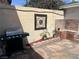 Charming patio area with a barbecue grill, brick details, and decorative accents at 565 Greenbriar Townhouse Way, Las Vegas, NV 89121