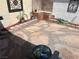 Private patio area featuring brick details, decorative stone accents, and a green garden hose at 565 Greenbriar Townhouse Way, Las Vegas, NV 89121