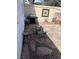 This outdoor patio area has rock features, brick details, barbecue, and an Adirondack chair at 565 Greenbriar Townhouse Way, Las Vegas, NV 89121