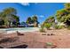 Community pool with lounge chairs and natural landscaping at 565 Greenbriar Townhouse Way, Las Vegas, NV 89121