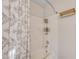 Shower/tub with neutral tile surround and decorative patterned shower curtain at 565 Greenbriar Townhouse Way, Las Vegas, NV 89121