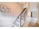 Staircase with carpeted steps, decorative gray banister and wood-look floors at 565 Greenbriar Townhouse Way, Las Vegas, NV 89121