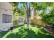 Lush backyard featuring a mature tree, manicured lawn, and privacy landscaping, ideal for outdoor enjoyment at 5908 Marbrisas Ln, Las Vegas, NV 89130