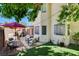 The backyard has artificial grass, outdoor seating, a patio, and mature shade trees at 5908 Marbrisas Ln, Las Vegas, NV 89130