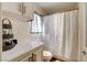 This bathroom offers a shower over tub, white cabinets and ample counter space at 5908 Marbrisas Ln, Las Vegas, NV 89130