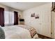 Well-lit bedroom with a cozy queen-sized bed, bedside table and hardwood floors throughout at 5908 Marbrisas Ln, Las Vegas, NV 89130
