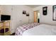 Well-lit bedroom with a queen-sized bed, bedside table, and an entertainment center at 5908 Marbrisas Ln, Las Vegas, NV 89130