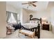 This bedroom features a ceiling fan and a bench seat to the foot of the bed at 5908 Marbrisas Ln, Las Vegas, NV 89130