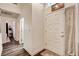 Bright entryway featuring laminate floors, neutral paint, and a practical coat closet at 5908 Marbrisas Ln, Las Vegas, NV 89130