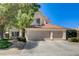 Charming home featuring a symmetrical design, a three-car garage, and a terracotta-tiled roof at 5908 Marbrisas Ln, Las Vegas, NV 89130