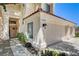 Stucco home featuring a three-car garage, a tiled roof, and meticulous landscaping at 5908 Marbrisas Ln, Las Vegas, NV 89130