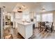 Bright kitchen with white cabinets, a kitchen island, and an adjacent breakfast area at 5908 Marbrisas Ln, Las Vegas, NV 89130