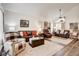 Spacious living room with laminate floors, neutral paint, and plenty of comfortable seating at 5908 Marbrisas Ln, Las Vegas, NV 89130