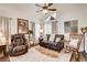 Cozy living room showcasing a plush leather sofa and chair near a bright window at 5908 Marbrisas Ln, Las Vegas, NV 89130
