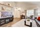 Bright living room featuring laminate floors, neutral paint, and vaulted ceilings at 5908 Marbrisas Ln, Las Vegas, NV 89130