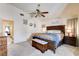Spacious main bedroom with a large bed, ceiling fan, and comfortable seating area with decorations at 5908 Marbrisas Ln, Las Vegas, NV 89130