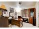 Inviting office space with a large desk, comfortable chair, and built-in cabinet for storage and display at 5908 Marbrisas Ln, Las Vegas, NV 89130