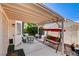 Cozy covered patio featuring a swing and outdoor seating, perfect for relaxing or entertaining guests at 5908 Marbrisas Ln, Las Vegas, NV 89130