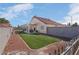 Spacious backyard features artificial turf, gravel landscaping, and a covered patio area for outdoor living at 6138 Crystal Flower Way, North Las Vegas, NV 89031