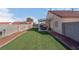 Large backyard with artificial grass, gravel landscaping, covered patio, perfect for outdoor relaxation at 6138 Crystal Flower Way, North Las Vegas, NV 89031