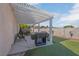 The backyard patio is covered and includes outdoor seating and barbecue at 6138 Crystal Flower Way, North Las Vegas, NV 89031