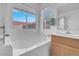 Bright bathroom featuring a bathtub and a separate sink with vanity at 6138 Crystal Flower Way, North Las Vegas, NV 89031