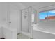 Bathroom featuring a glass enclosed shower and a white soaking tub at 6138 Crystal Flower Way, North Las Vegas, NV 89031