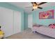 Light and airy bedroom includes ceiling fan, large closet and playful décor at 6138 Crystal Flower Way, North Las Vegas, NV 89031