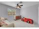 Cozy bedroom with large window, a ceiling fan and car-shaped bed for  at 6138 Crystal Flower Way, North Las Vegas, NV 89031