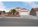 Charming single-story home with a tile roof, two-car garage, desert landscaping, and covered front porch at 6138 Crystal Flower Way, North Las Vegas, NV 89031