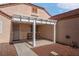 Cozy front patio with pergola cover, seating, and desert landscaping, perfect for enjoying the outdoors at 6138 Crystal Flower Way, North Las Vegas, NV 89031