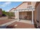 Cozy front patio with pergola cover, seating, and desert landscaping, perfect for enjoying the outdoors at 6138 Crystal Flower Way, North Las Vegas, NV 89031