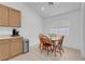 Bright kitchen with light wood cabinets, tile floors, and a dining table with chairs at 6138 Crystal Flower Way, North Las Vegas, NV 89031