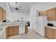 Bright open kitchen features light wood cabinets, white appliances, and tiled floor at 6138 Crystal Flower Way, North Las Vegas, NV 89031