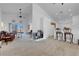 Open concept living space with vaulted ceilings, neutral carpet, and a sliding glass door to the backyard at 6138 Crystal Flower Way, North Las Vegas, NV 89031