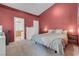 Cozy main bedroom featuring a red accent wall and an ensuite bathroom at 6138 Crystal Flower Way, North Las Vegas, NV 89031