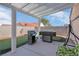 Covered patio area features an outdoor kitchen with a built-in BBQ, ideal for entertaining guests at 6138 Crystal Flower Way, North Las Vegas, NV 89031