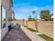 Spacious backyard featuring a brick patio, stylish outdoor seating, and well-maintained landscaping at 66 Chelsea Manor Ct, Las Vegas, NV 89110