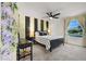 Bright bedroom with modern decor, black and gold wallpaper accents, and a large window at 66 Chelsea Manor Ct, Las Vegas, NV 89110
