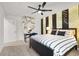 Stylish bedroom with striped accent wall, vanity area, ceiling fan, and carpet flooring at 66 Chelsea Manor Ct, Las Vegas, NV 89110