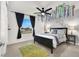 Comfortable bedroom featuring a black bed frame, a window view, and floral decorative wall hangings at 66 Chelsea Manor Ct, Las Vegas, NV 89110