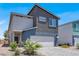 Modern two-story home featuring a two-car garage, neutral color palette and low maintenance landscaping at 66 Chelsea Manor Ct, Las Vegas, NV 89110