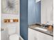 Chic half bath features modern vanity, neutral decor and a framed artistic print at 66 Chelsea Manor Ct, Las Vegas, NV 89110