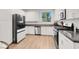 Bright kitchen with stainless steel appliances, gray countertops and white cabinetry at 66 Chelsea Manor Ct, Las Vegas, NV 89110