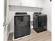 Modern laundry room with gray washer and dryer, plus white cabinets for storage at 66 Chelsea Manor Ct, Las Vegas, NV 89110