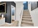 Carpeted staircase with white railing and an adjacent half bath offering access to the upper level at 66 Chelsea Manor Ct, Las Vegas, NV 89110