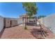 Spacious backyard with gazebo-covered seating area, storage sheds, and desert landscaping at 690 Great Dane Ct, Henderson, NV 89052